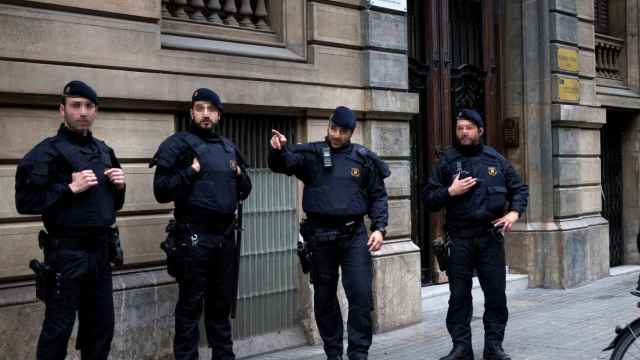 Agentes de los Mossos D'Esquadra custodian la sede de Omnium mientras la Guardia Civil requiere documentación.